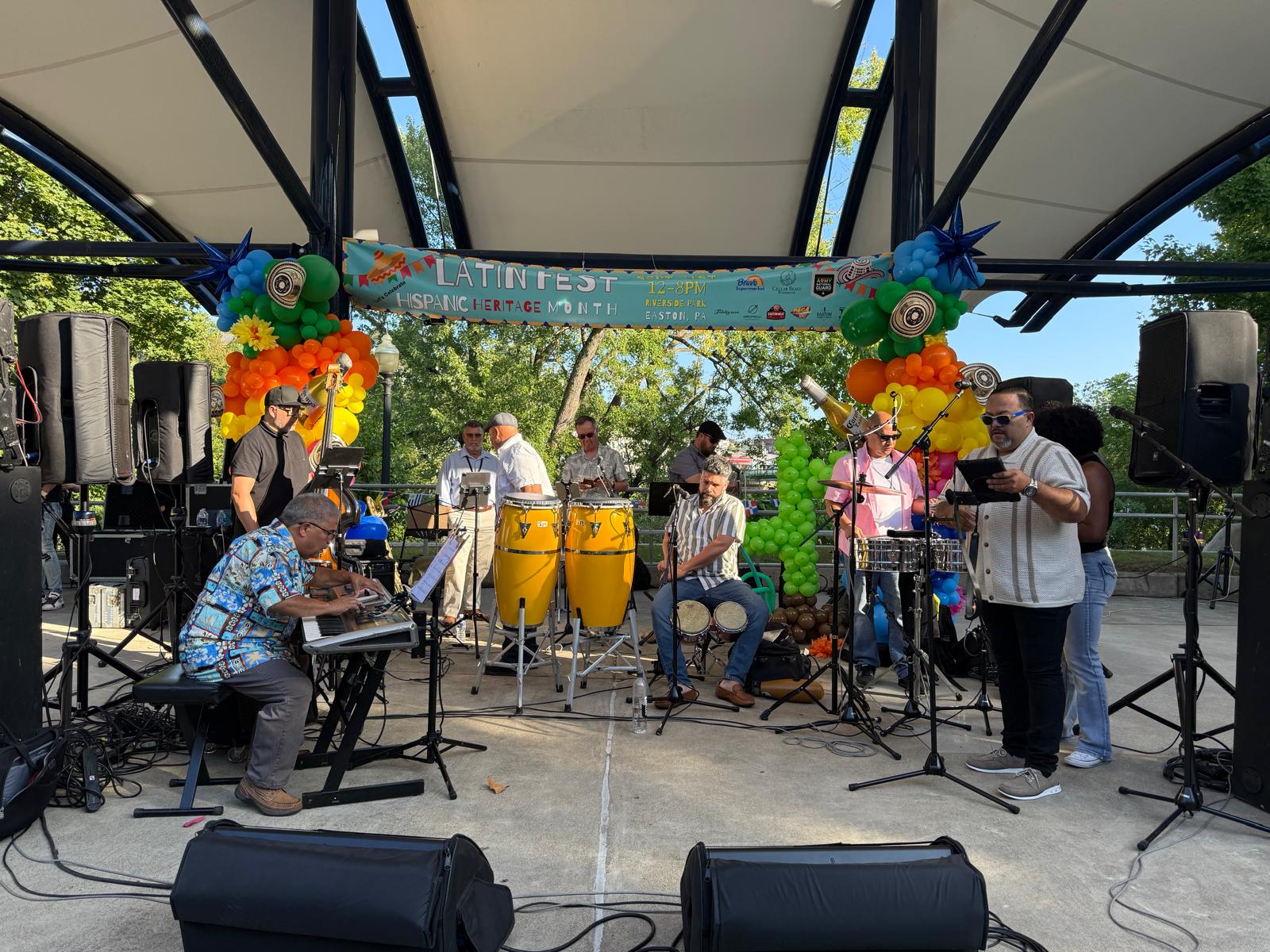 Full salsa orchestra performing on the outdoor stage